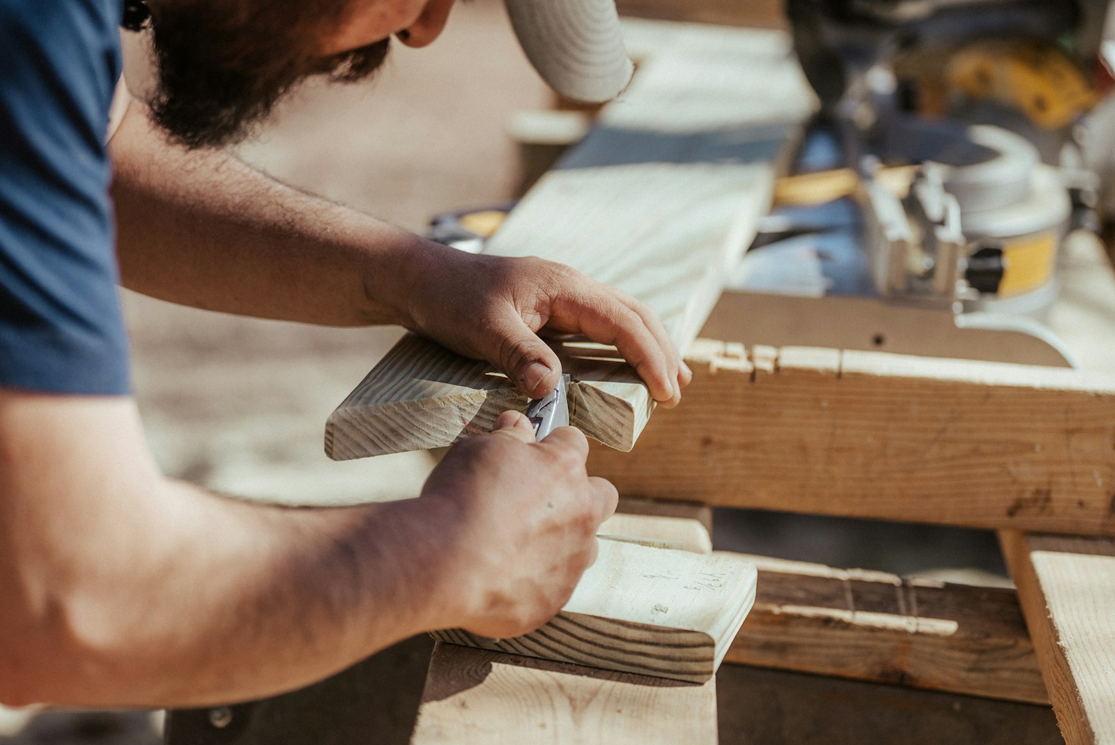 a man working on a piece of wood, General Liability